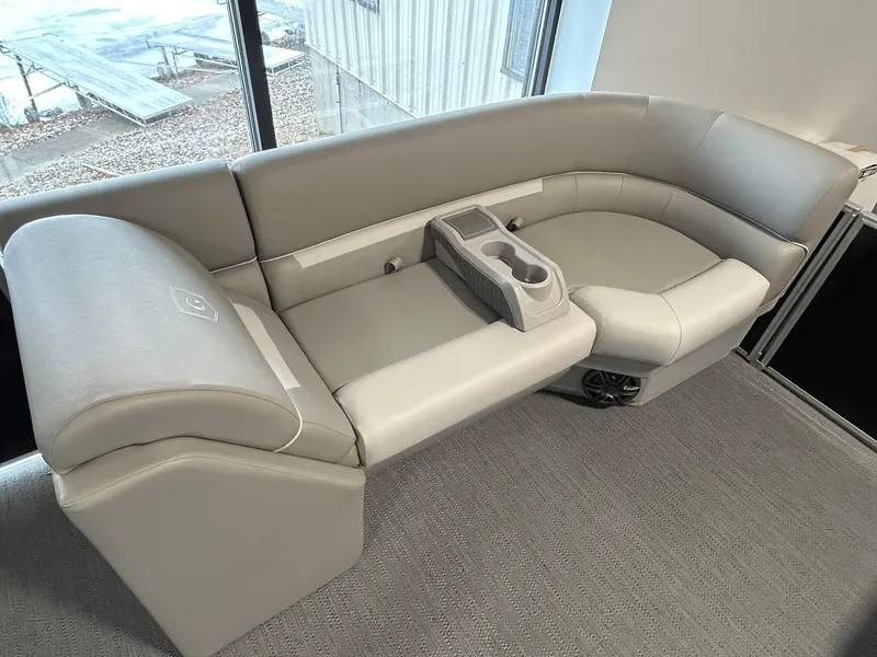 Slide: The Image of 2025 Godfrey Xperience 2286 SBX boat seating with cup holders, in a showroom setting. - 3
