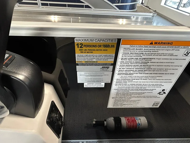 Slide: The Image of 2025 Godfrey Xperience 2286 SBX boat capacity label, maximum 12 persons or 1660 lbs. - 7