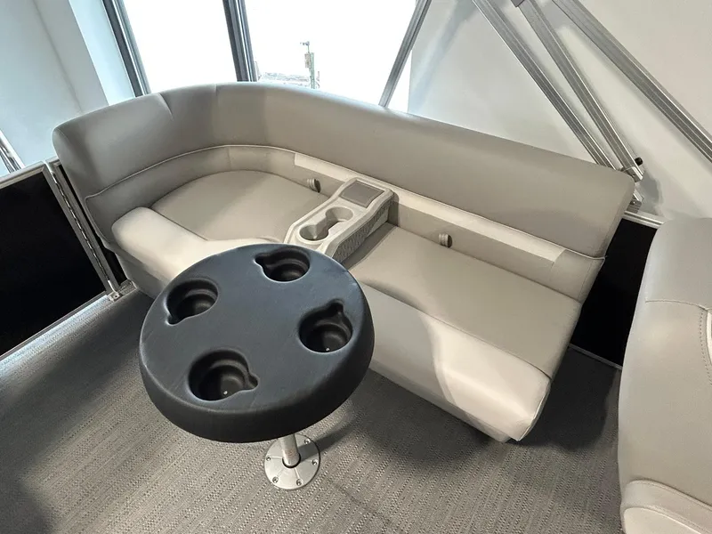 Slide: The Image of Interior seating of 2025 Godfrey Xperience 2286 SBX with cup holders and table. - 9