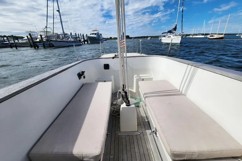 Slide: The Image of Cockpit view of 2017 Rustler 33 sailboat with marina backdrop. - 10
