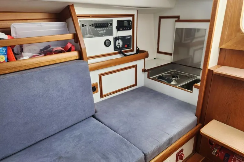 Slide: The Image of Interior of a 2017 Rustler 33 sailboat with seating and control panel. - 4