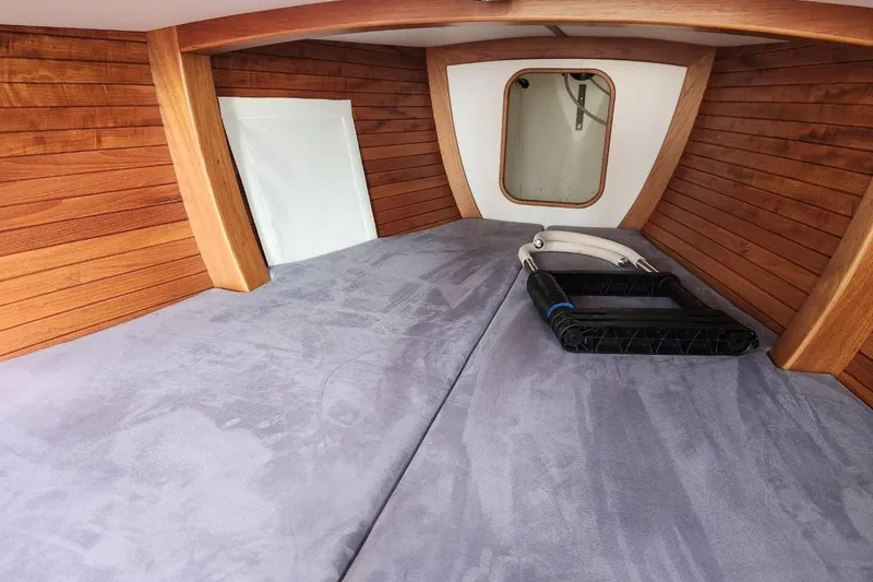 Slide: The Image of Interior cabin of 2017 Rustler 33 sailboat with wooden paneling and cozy bedding. - 6