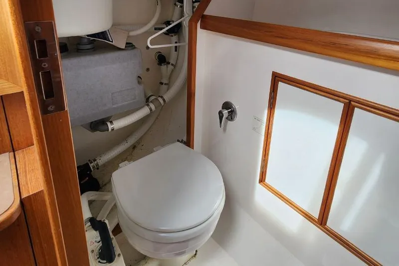 Slide: The Image of Compact marine bathroom in 2017 Rustler 33 yacht with wooden accents and plumbing. - 7