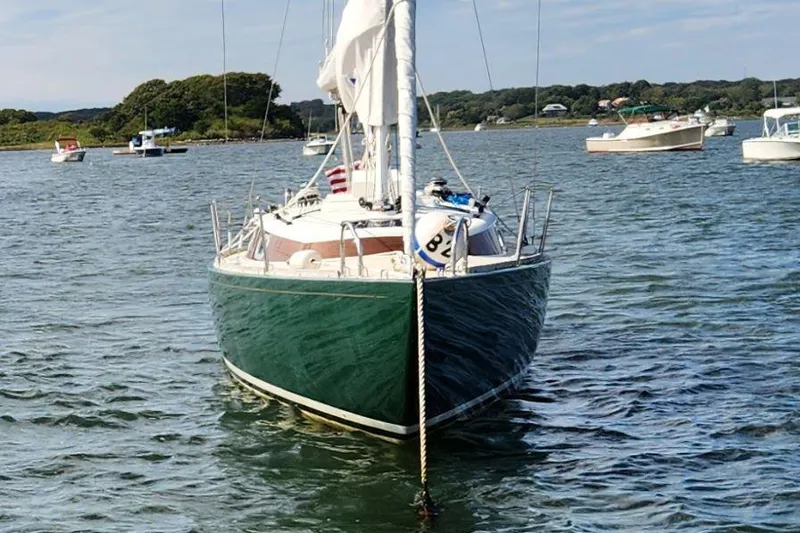 Slide: The Image of 2017 Rustler 33 sailboat anchored in a scenic harbor. - 8
