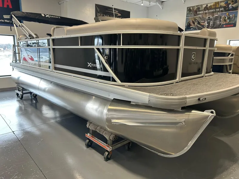 Slide: The Image of 2025 Godfrey Xperience 2086 SBX pontoon boat in showroom, sleek design, black and silver finish. - 0
