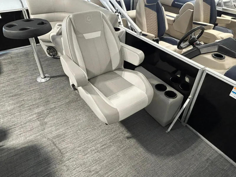 Slide: The Image of Captain's chair on 2025 Godfrey Xperience 2086 SBX pontoon boat, featuring cup holders and table. - 11