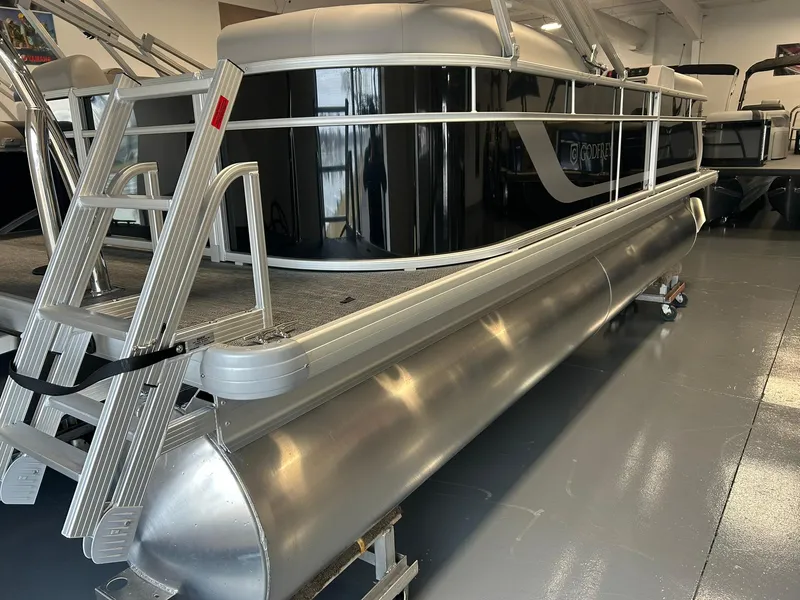 Slide: The Image of 2025 Godfrey Xperience 2086 SBX pontoon boat in showroom, featuring sleek design and aluminum pontoons. - 16