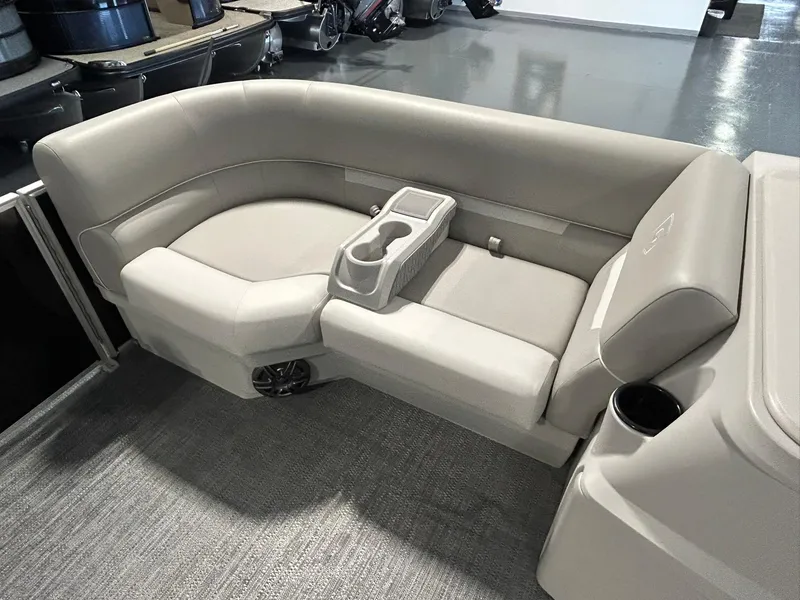 Slide: The Image of 2025 Godfrey Xperience 2086 SBX boat interior with beige seating and cup holders. - 3