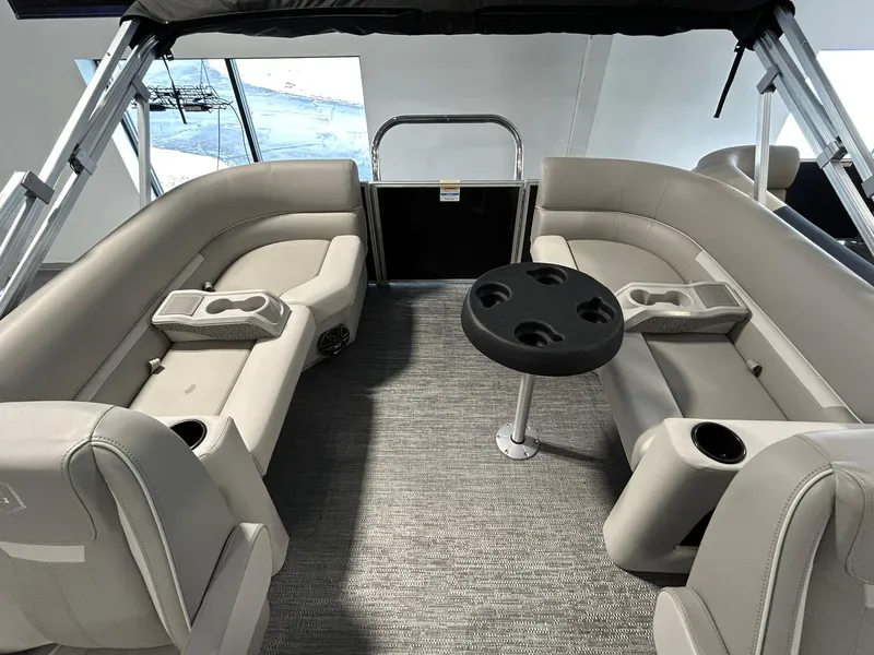 Slide: The Image of 2025 Godfrey Xperience 2086 SBX boat interior with beige seating and cup holders. - 8