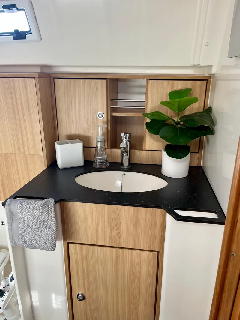 Slide: The Image of Modern bathroom interior of 2011 Bavaria 36 Cruiser yacht with wooden cabinets and sleek sink. - 10