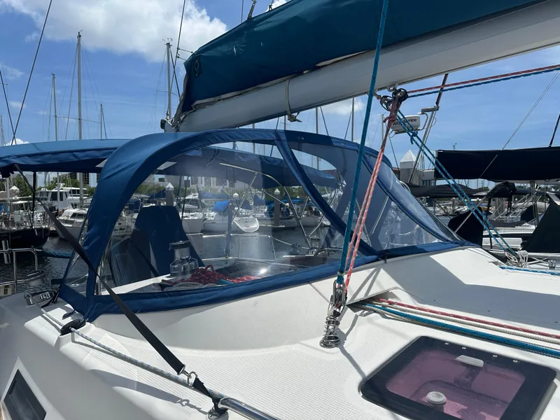 Slide: The Image of Bavaria 36 Cruiser 2011 sailboat with blue canopy docked at marina under clear sky. - 16