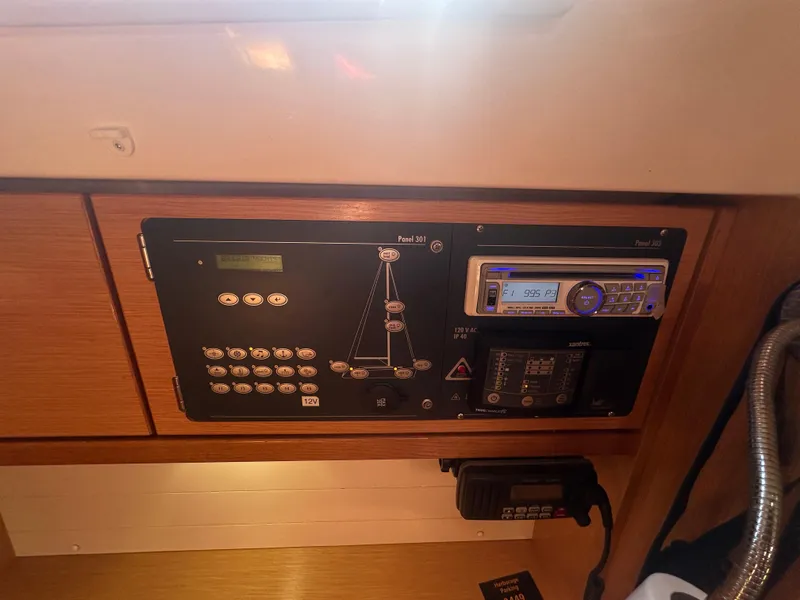 Slide: The Image of Control panel of a 2011 Bavaria 36 Cruiser yacht, featuring navigation and communication equipment. - 19
