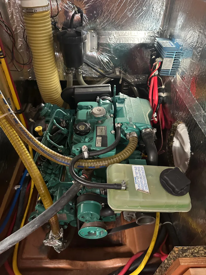 Slide: The Image of Engine compartment of a 2011 Bavaria 36 Cruiser sailboat, showcasing mechanical components and wiring. - 20