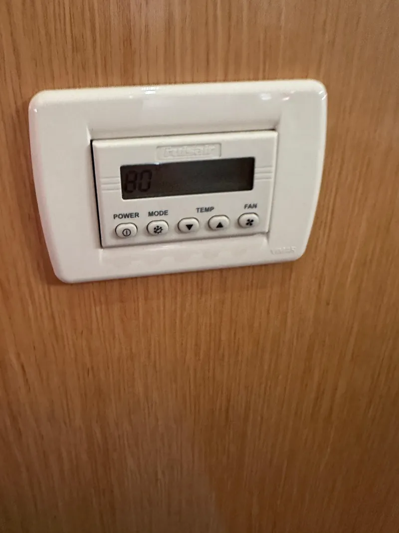 Slide: The Image of Thermostat control panel on Bavaria 36 Cruiser yacht, 2011 model, mounted on wooden surface. - 21