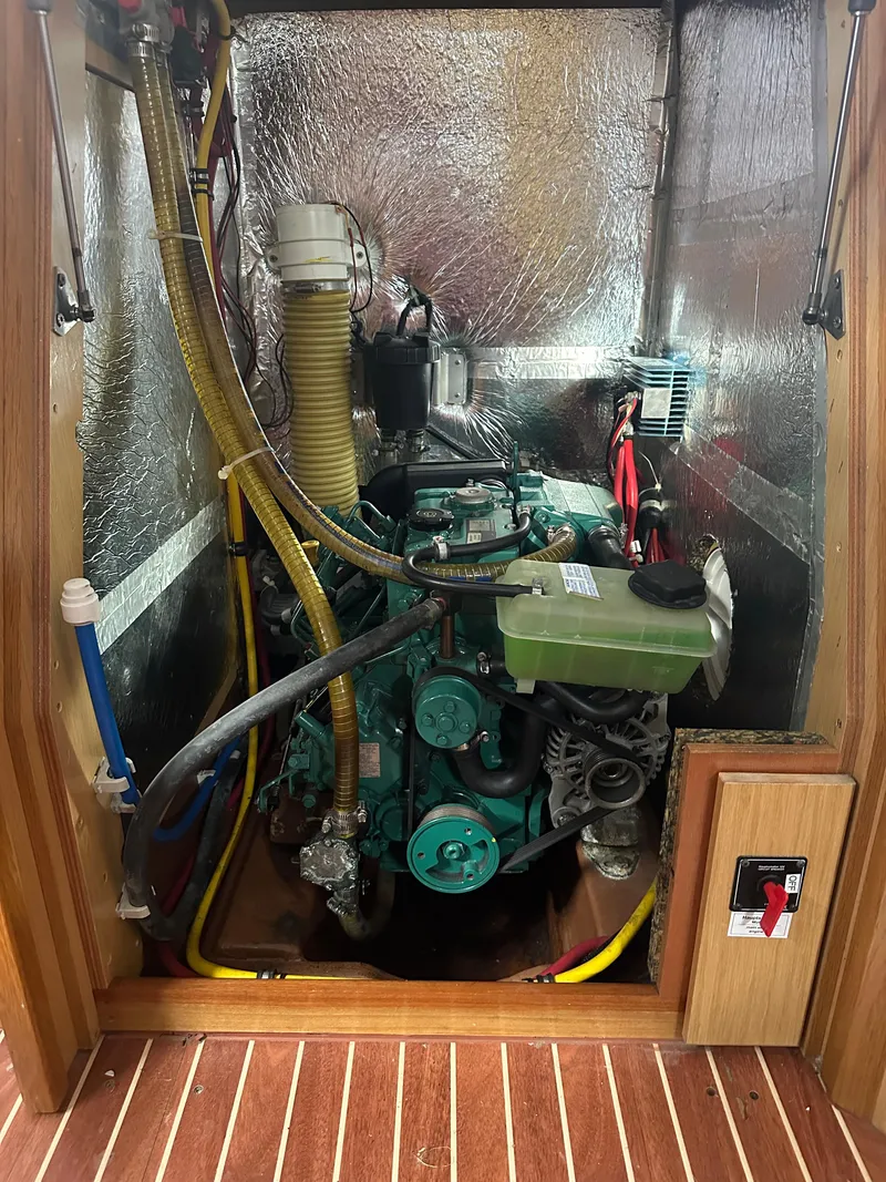 Slide: The Image of Engine compartment of a 2011 Bavaria 36 Cruiser sailboat, showcasing mechanical components. - 22