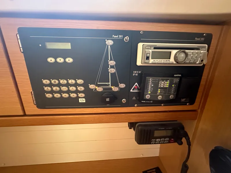 Slide: The Image of Control panel of a 2011 Bavaria 36 Cruiser yacht, featuring navigation and communication equipment. - 26
