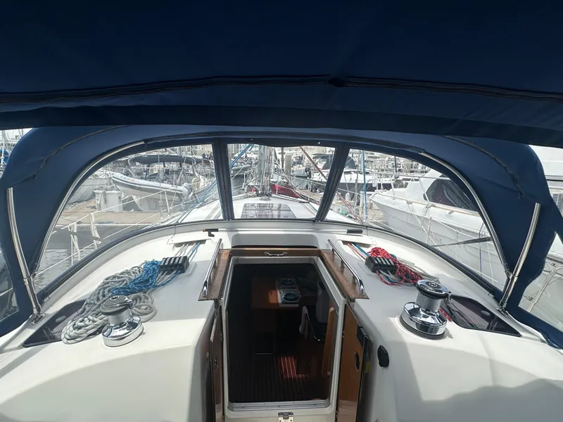 Slide: The Image of Cockpit view of 2011 Bavaria 36 Cruiser sailboat in marina, featuring ropes and winches. - 27