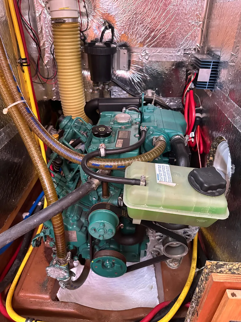 Slide: The Image of Engine compartment of a 2011 Bavaria 36 Cruiser sailboat, featuring detailed mechanical components. - 31