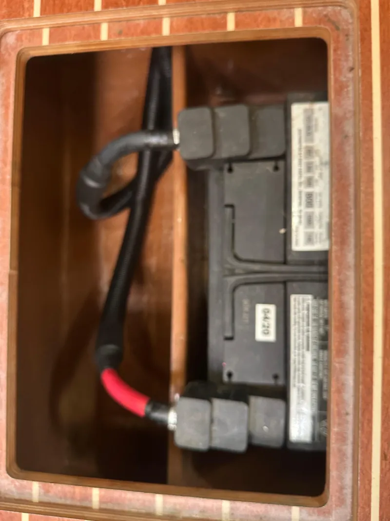 Slide: The Image of Battery compartment of a 2011 Bavaria 36 Cruiser sailboat, featuring wiring and connections. - 35
