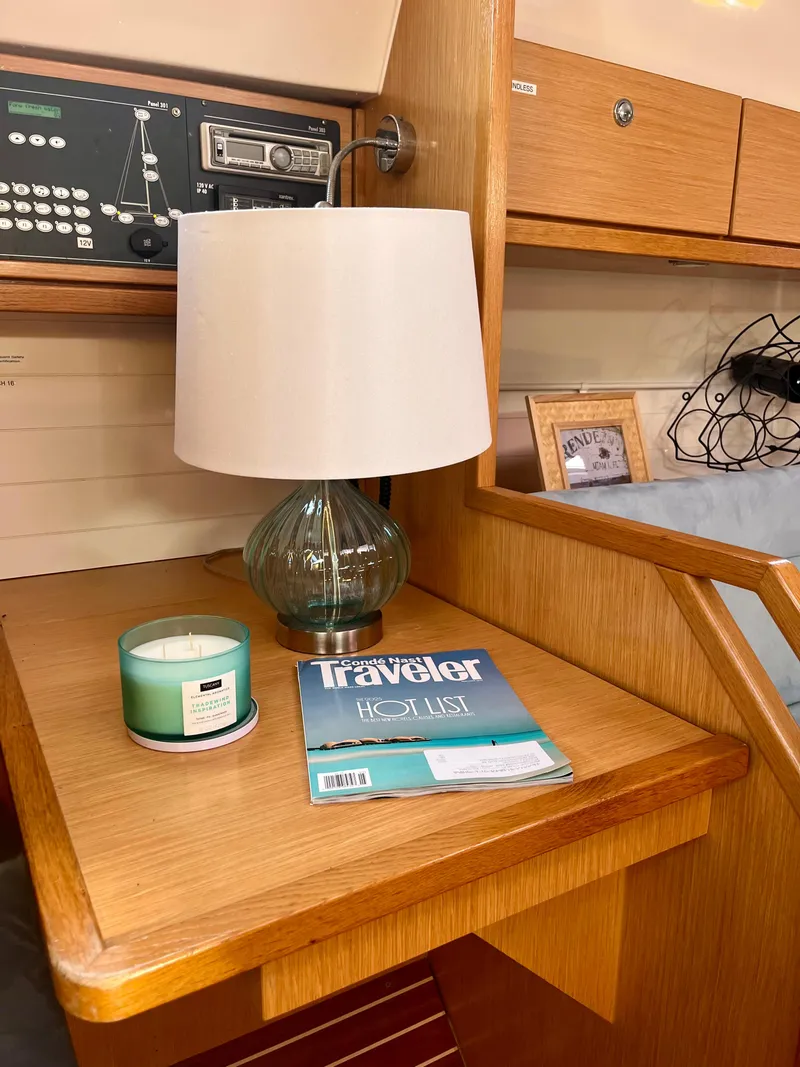 Slide: The Image of Interior of 2011 Bavaria 36 Cruiser with lamp, magazine, and candle on wooden desk. - 9