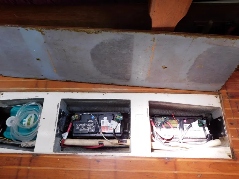 Slide: The Image of 1984 Endeavour 35.5 Sloop battery compartment with wiring and storage. - 14