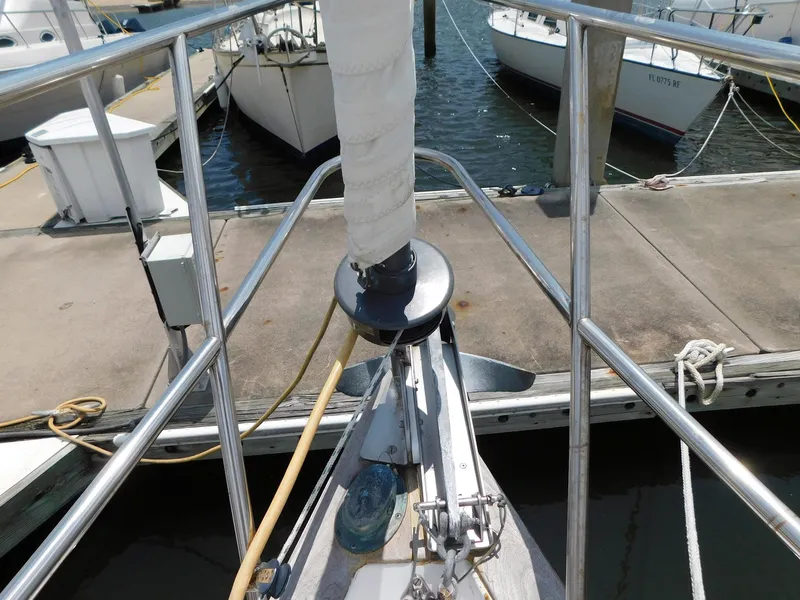 Slide: The Image of 1984 Endeavour 35.5 Sloop docked at marina, bow view with railing and anchor. - 21