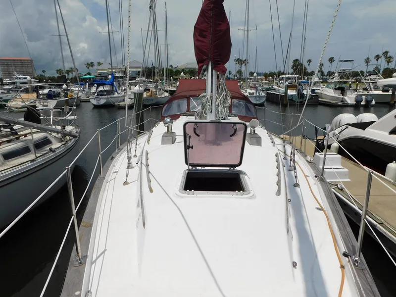 Slide: The Image of 1984 Endeavour 35.5 Sloop docked in marina, view of deck and open hatch. - 24