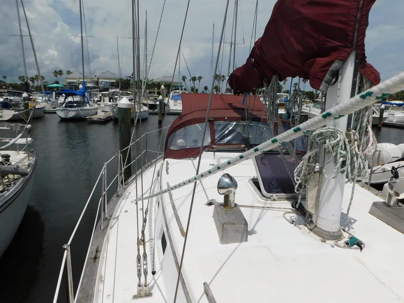 Slide: The Image of 1984 Endeavour 35.5 Sloop docked in a marina, surrounded by other sailboats. - 25