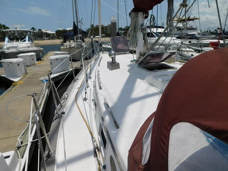 Slide: The Image of 1984 Endeavour 35.5 Sloop docked at marina, sunny day, sailboats in background. - 28