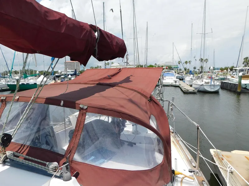 Slide: The Image of 1984 Endeavour 35.5 Sloop docked in a marina with red canvas cover. - 29