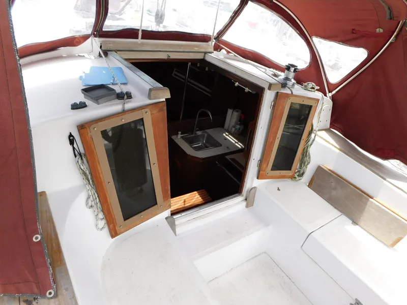 Slide: The Image of 1984 Endeavour 35.5 Sloop cockpit with open hatch and visible interior sink. - 31