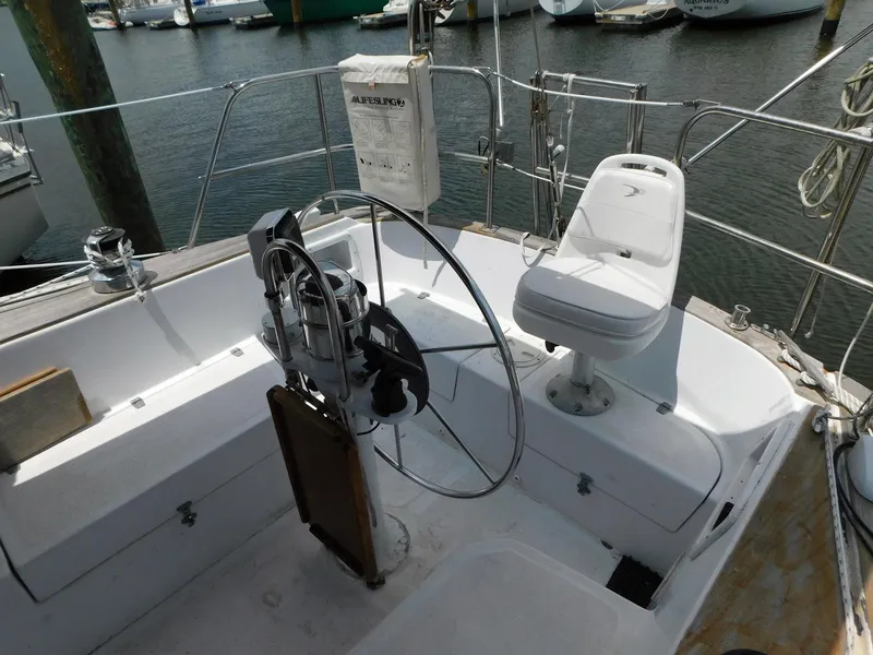 Slide: The Image of 1984 Endeavour 35.5 Sloop cockpit with steering wheel and seating at marina. - 33