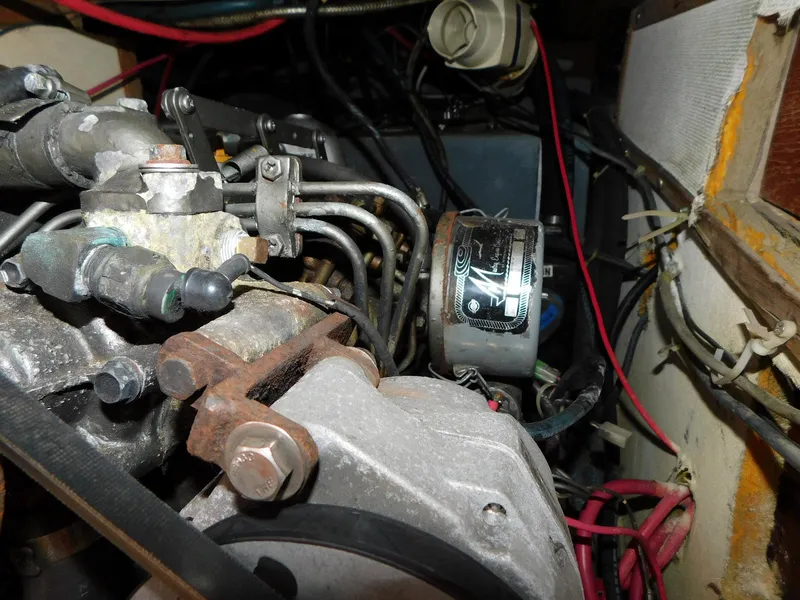 Slide: The Image of Engine components of a 1984 Endeavour 35.5 Sloop sailboat, showcasing intricate wiring and mechanics. - 43