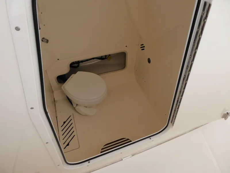 Slide: The Image of 2017 Boston Whaler 250 Outrage boat interior with compact marine toilet. - 11