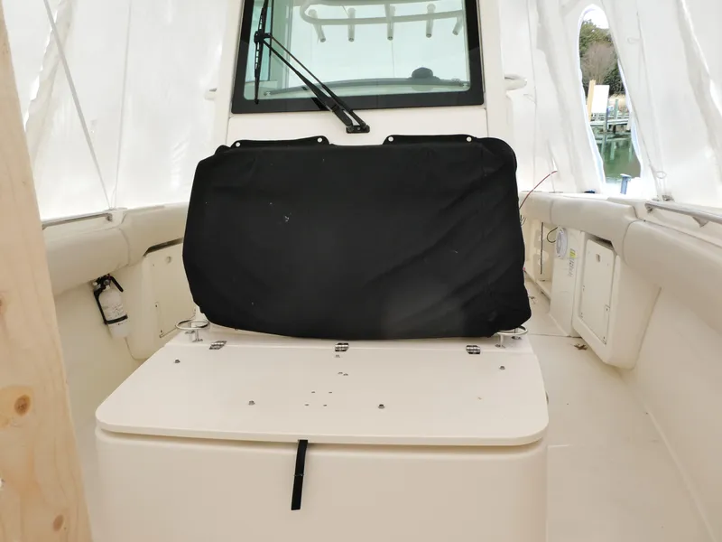 Slide: The Image of 2017 Boston Whaler 250 Outrage interior with covered seating and windshield. - 12
