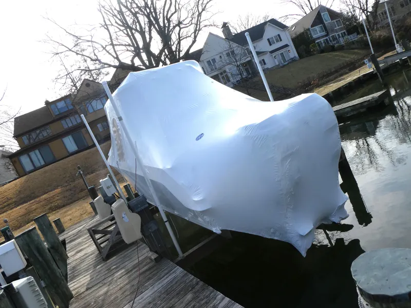 Slide: The Image of Covered 2017 Boston Whaler 250 Outrage on dock, winterized with shrink wrap. - 2