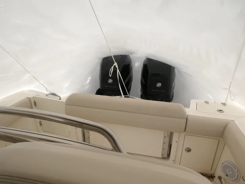Slide: The Image of 2017 Boston Whaler 250 Outrage boat interior with dual engines, covered in protective wrap. - 3