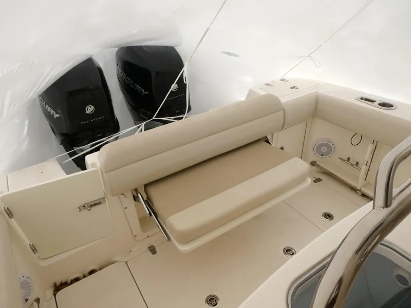 Slide: The Image of 2017 Boston Whaler 250 Outrage boat interior with seating and dual Mercury engines. - 5