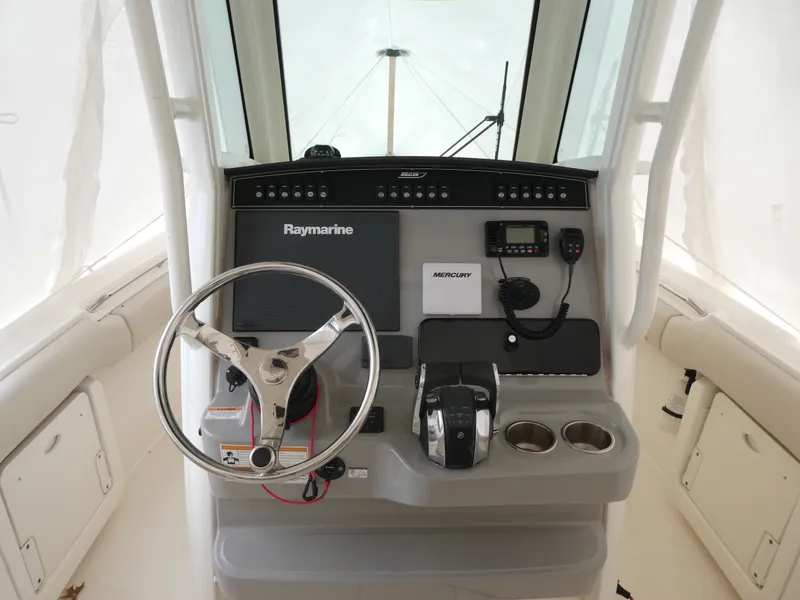 Slide: The Image of 2017 Boston Whaler 250 Outrage helm with Raymarine electronics and Mercury controls. - 6
