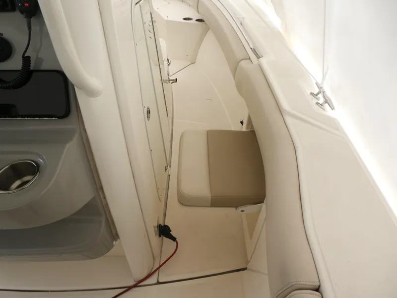 Slide: The Image of 2017 Boston Whaler 250 Outrage interior with beige seating and storage compartments. - 8