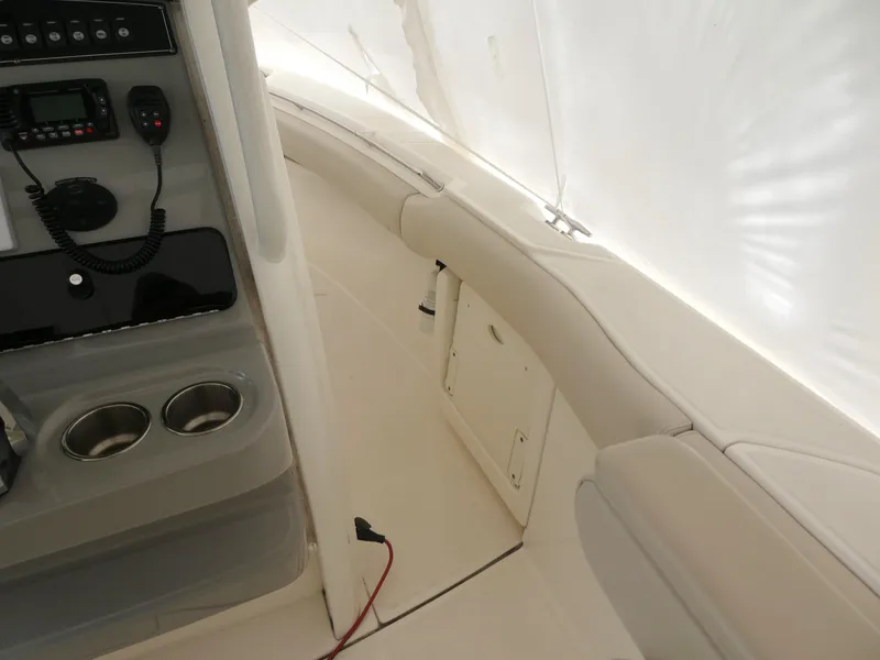 Slide: The Image of Interior view of 2017 Boston Whaler 250 Outrage boat, featuring seating and control panel. - 9