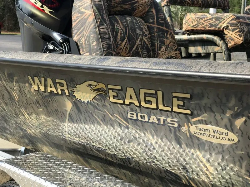 Slide: The Image of War Eagle Blackhawk 2170 boat, camo design, Team Ward Monticello AR logo, 2025 model. - 10