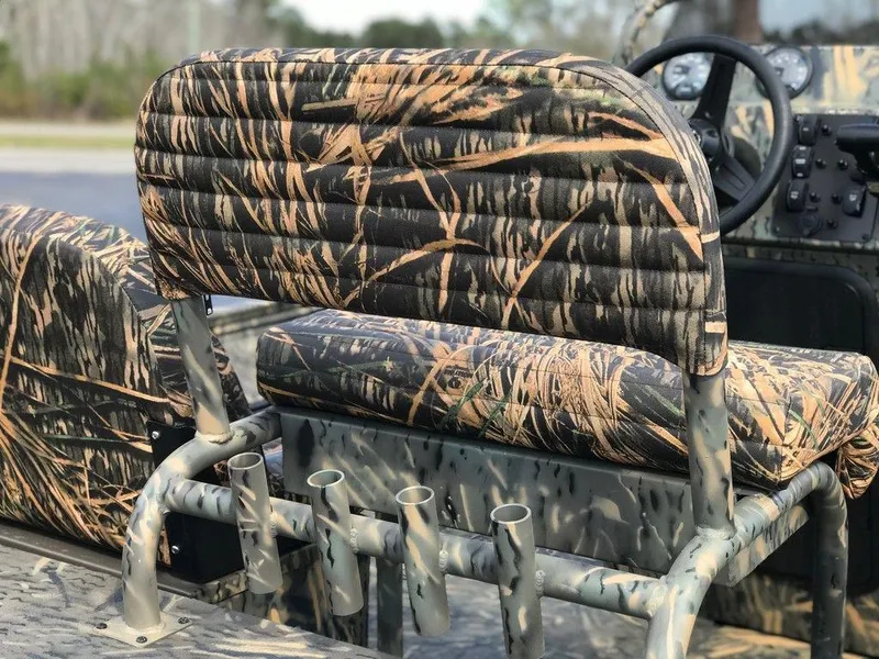 Slide: The Image of Camouflage seating in 2025 War Eagle Blackhawk 2170 boat, featuring rod holders and steering console. - 2
