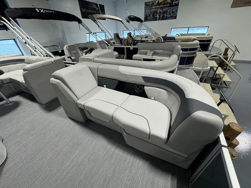 Slide: The Image of 2025 Godfrey Sweetwater 2086 C pontoon boat interior with luxurious seating in showroom. - 5