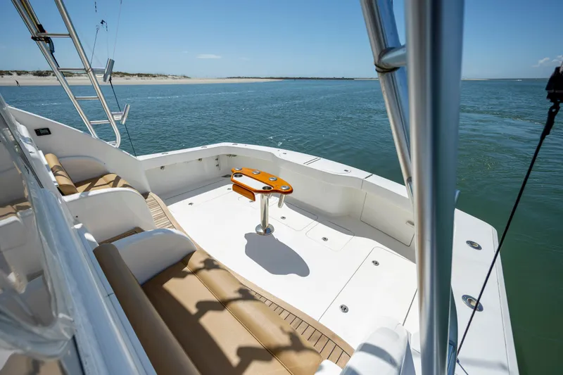 Slide: The Image of 2013 Viking 42 yacht deck with seating, ocean view, and clear blue sky. - 15