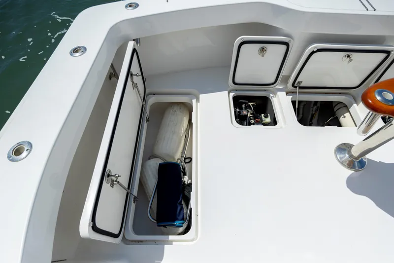 Slide: The Image of 2013 Viking 42 boat deck with open storage compartments and visible equipment. - 16