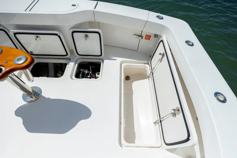 Slide: The Image of Viking 42 yacht deck, 2013 model, featuring storage compartments and fishing rod holder. - 17