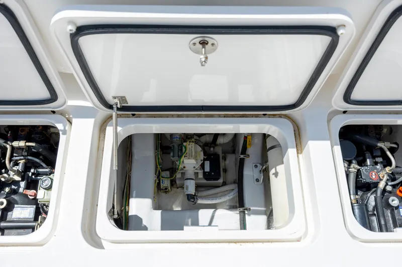 Slide: The Image of Engine compartment of a 2013 Viking 42 boat, showcasing mechanical components and storage. - 19