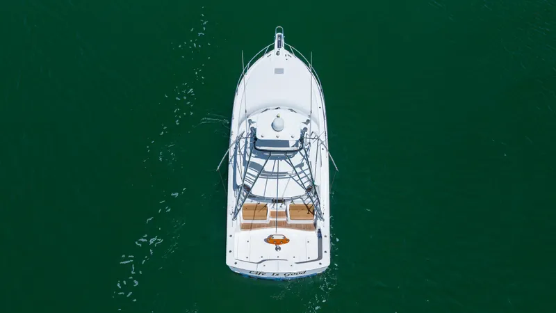 Slide: The Image of Aerial view of 2013 Viking 42 yacht on calm green water. - 2
