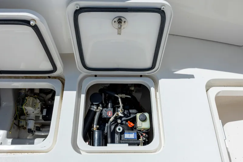 Slide: The Image of Engine compartment of a 2013 Viking 42 boat, showcasing mechanical components and open hatches. - 20